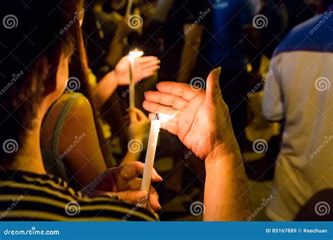 People Holding Candle Vigil In Darkness Seeking Hope Worship P Stock