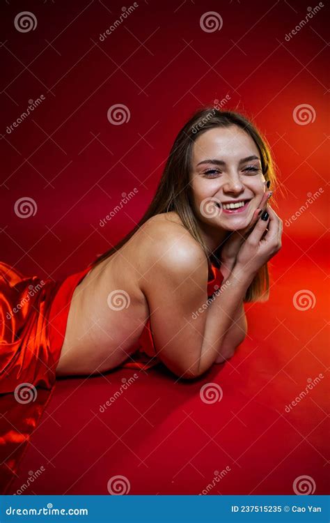 Portrait Of A Gorgeous Blonde With Long Beautiful Hair And Body Wrapped In Red Silk Stock Image