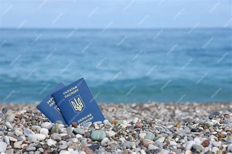 Premium Photo Two Biometrical Ukrainian Passports On Sea Shore Background