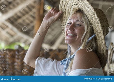 Happy Beautiful Young Woman In A Straw Hat On A Tropical Beach Close