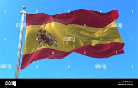 Spain flag waving at wind with blue sky. 3d render Stock Photo - Alamy