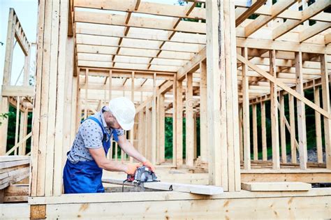 Carpenter Using Circular Saw For Cutting Wooden Plank While Building