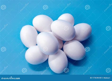 A Dozen White Chicken Eggs Lie On A Blue Background Eggs Are Shown In