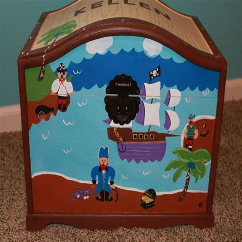 A Wooden Toy Chest With Pirate Scenes Painted On The Front And Sides