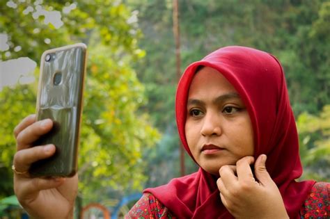 Premium Photo Close Up Of Woman Wearing Red Hijab While Taking Selfie