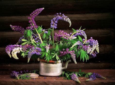 Purple Flowers In A Silver Pot On A Wooden Table