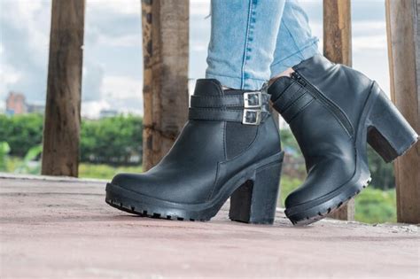 Premium Photo Closeup Detail Of A Latina Girl In Blue Jeans And Black Synthetic Leather Ankle