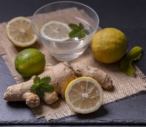 Composition Of Ginger And Lemon With Green Leaves And A Container With