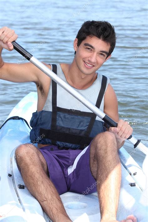 Dark Haired Boy Paddling In A Canoe Stock Photo Photography33 11066668