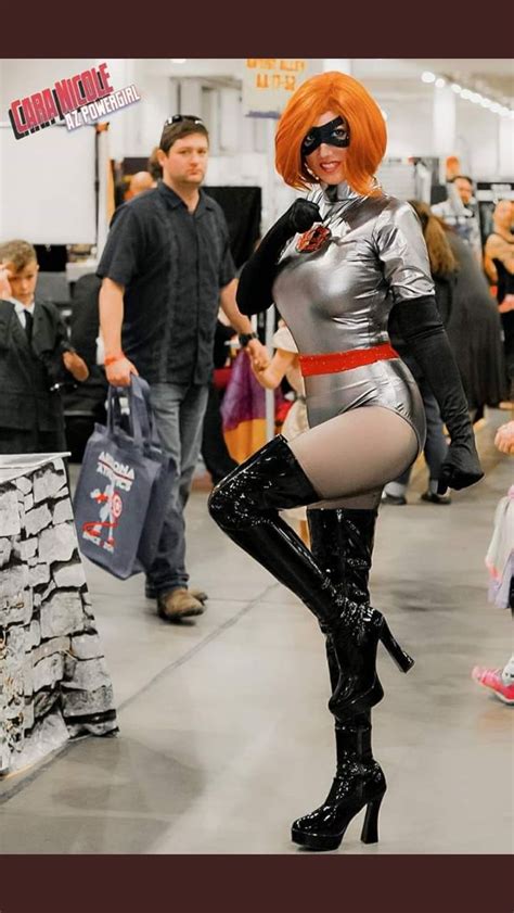 A Woman Dressed In Silver And Black Posing For The Camera