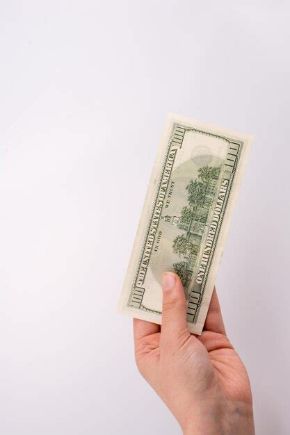 Premium Photo Cropped Hand Of Woman Holding Paper Currency Against