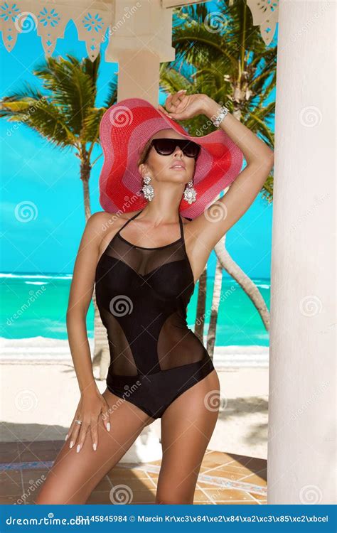 Beautiful Woman In Bikini And Hat Posing On The Caribbean Beach Stock