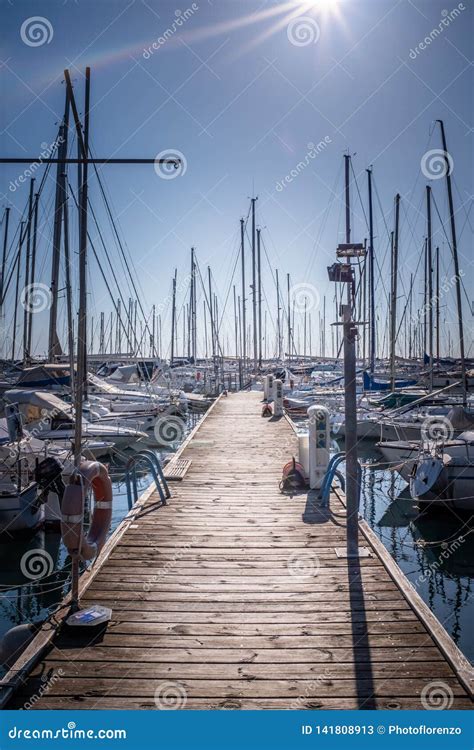 Wooden Pier With Many Boats And Yachts In Marina Harbor Stock Image