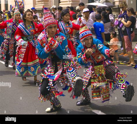 People In Traditional Peruvian Dress Dancing In The Street In Lima