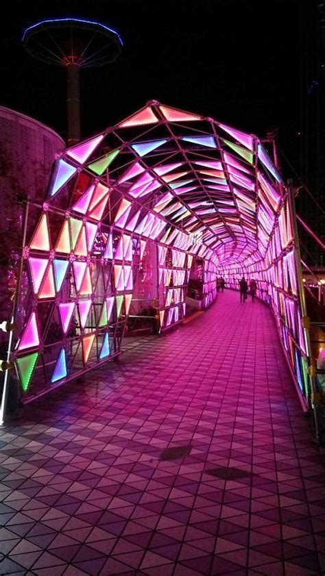 The Walkway Is Lit Up With Colorful Lights