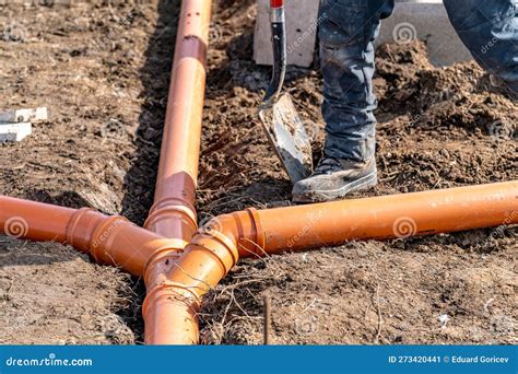 Installation of a Sewage Plastic Pipe during the Construction of a ...