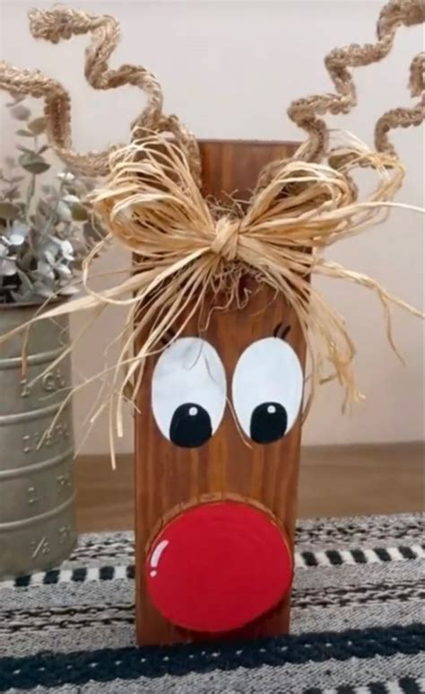 A Close Up Of A Wooden Block With A Reindeer Face On It S Head