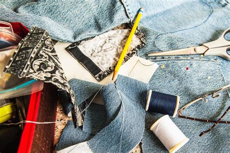 Set Of Tailoring Tools Accessories And Fabric On Table Stock Photo