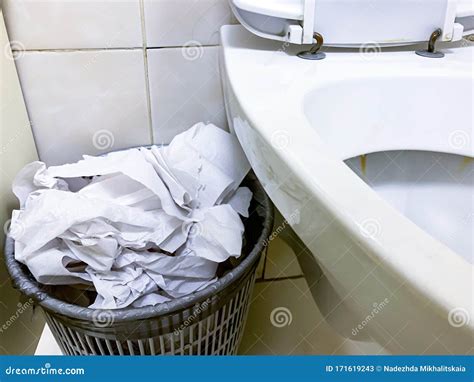 Overflowing Trash Can Dustbin Full Of Used Toilet Paper Near The