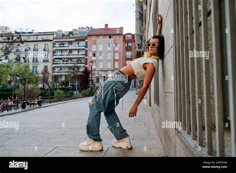 Gay Fashion Man Posing Against The Wall In Ripped Jeans And Crop Top Stock Photo Alamy