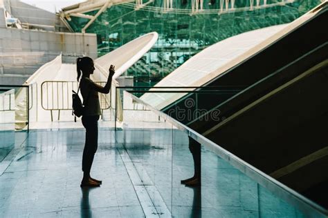 Silueta Contra La Luz De La Mujer Joven Que Toma Las Fotos Imagen De