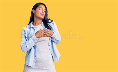 Hispanic Woman With Long Hair Wearing Casual Denim Jacket Smiling With