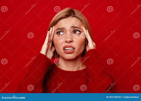 Unhappy Blonde Woman With Headache Rubbing Her Temples Isolated Over