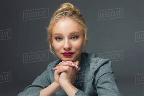 Attractive Smiling Blonde Girl Looking At Camera Isolated On Grey Royalty Free Stock Photo