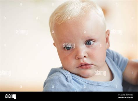 Newborn Baby With Blonde Hair And Blue Eyes