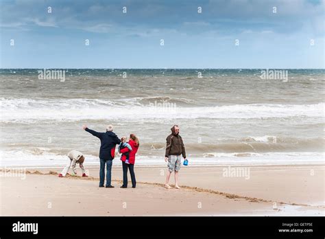 A family on Happisburgh Beach Stock Photo - Alamy