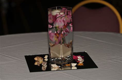 Our Centerpieces Submerged Orchid In Water With A Floating Candle On