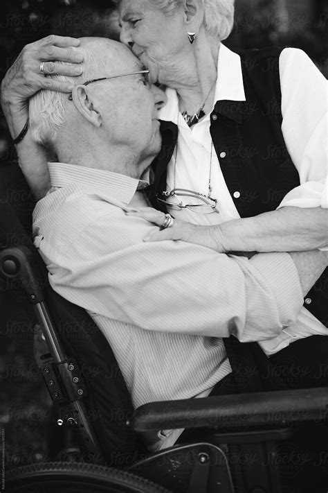 "Tender Moment Between Senior Couple Outside Together With Wheelchair