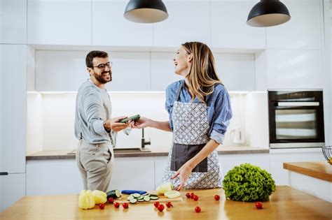 Premium Photo Handsome Happy Caucasian Couple Standing In Kitchen And