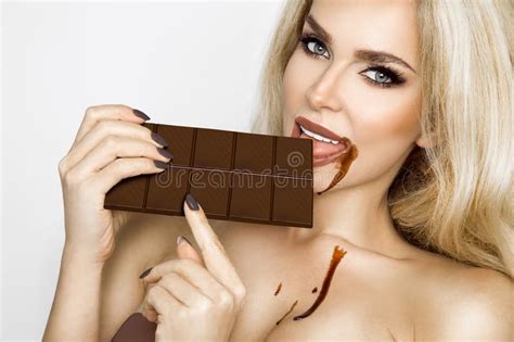 Beautiful Blonde Women With Green Eyes Sensually Eating Tasty Chocolate Stock Photo Image Of