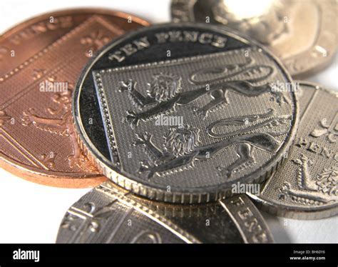 New British Ten Pence Coin With Lion Motif And Other Coins Under It