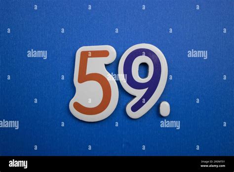 The number 59, placed on a blue background, photographed from above ...