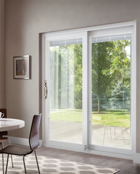 A Dining Room With Sliding Glass Doors Leading To An Outside Patio Area