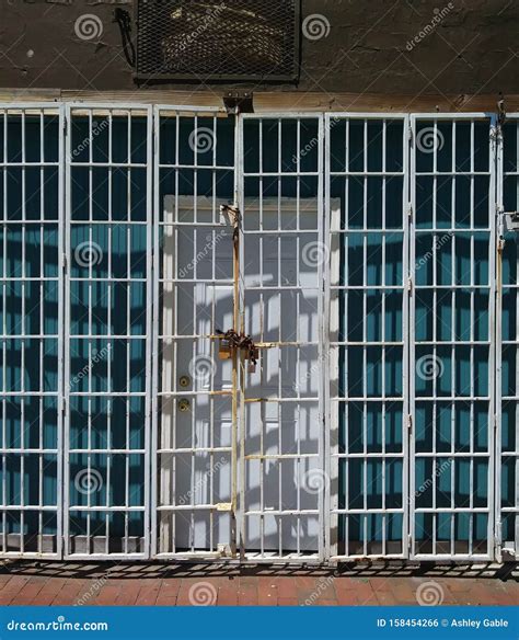 Urban Building Entrance: Door and Locked Security Gate. Stock Photo