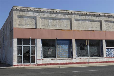 Old Abandoned Commercial Building With Boarded Up Windows 14516519