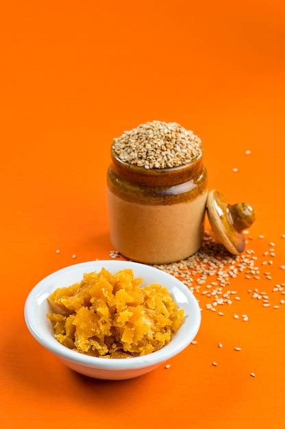 Premium Photo Sesame Seeds In Clay Pot With Jaggery In Bowl