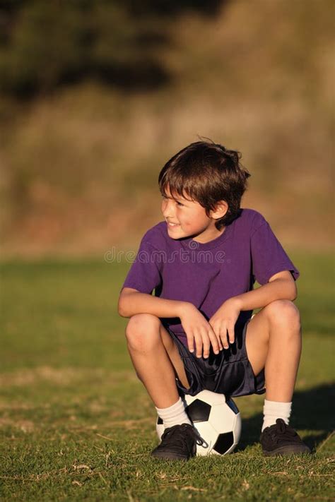 Boy sitting on soccer ball stock photo. Image of competition - 22688214