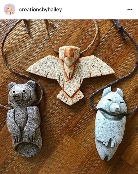 Three Ornaments Made Out Of Clay On A Wooden Floor Including Two Bears