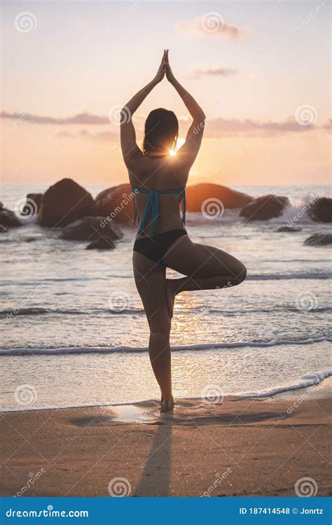 Young Attractive Latin Woman Wearing A Bikini Practicing Yoga On The