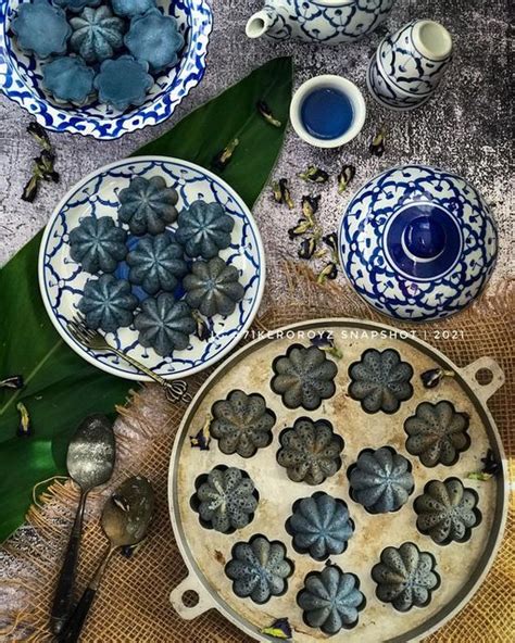 Blue And White Dishes With Flowers In Them On A Table Cloth Next To