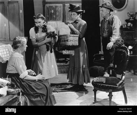 CLARA BLANDICK as Auntie Em JUDY GARLAND as Dorothy Gale TOTO the dog MARGARET HAMILTON as Miss ...