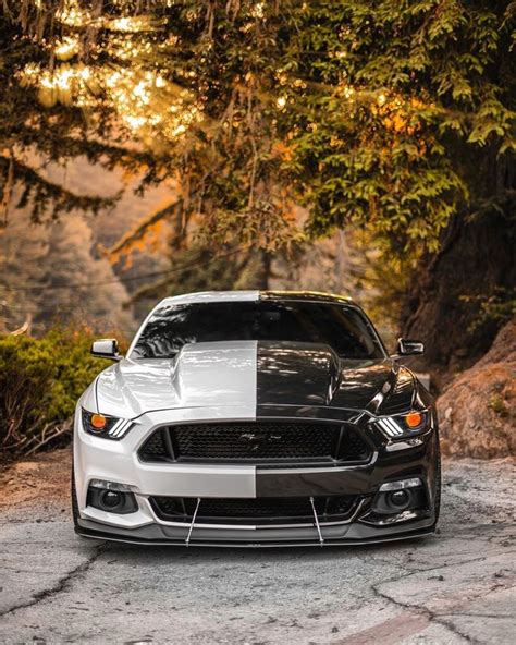 The Front End Of A Black And White Mustang