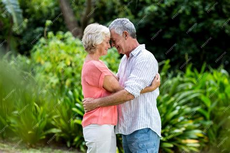 Premium Photo Senior Couple Embracing At Yard