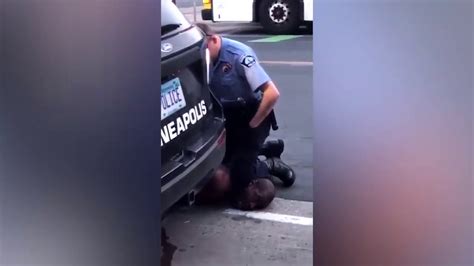 Minneapolis Police Officer Pinning Down A Black Man By The Neck With