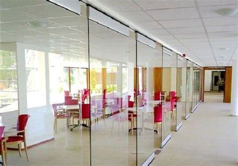 the inside of an office building with glass walls and pink chairs in ...