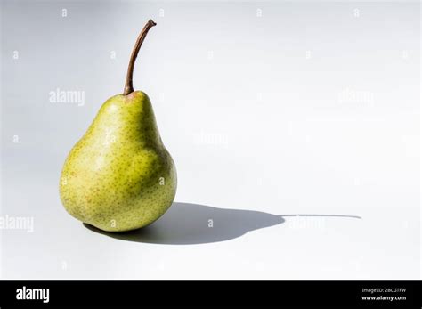 Pear fruit with a shadow Stock Photo - Alamy